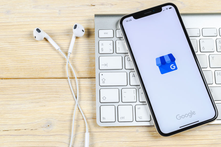 Smartphone On Keyboard Displaying Google My Business App