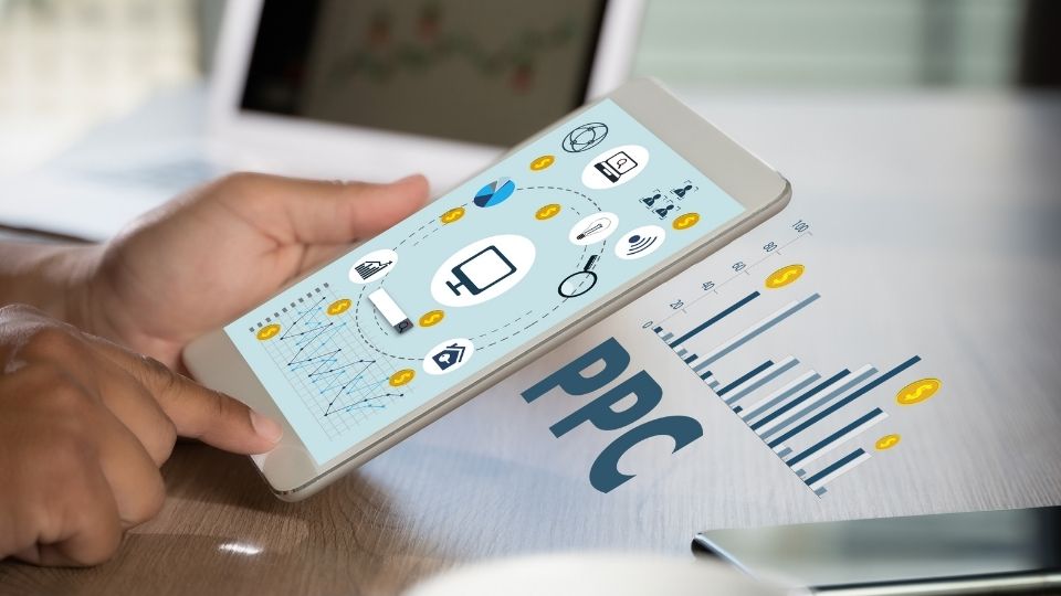 Smartphone Displaying Social Media Icons With PPC Text