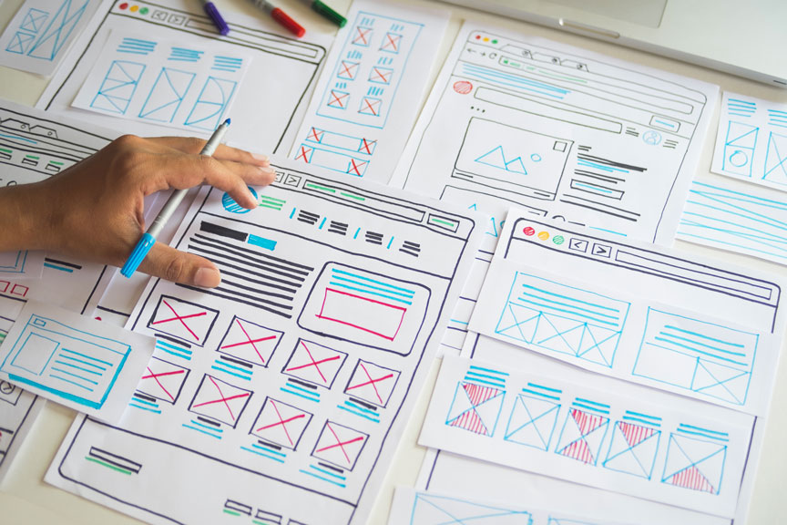 Team Analyzing A Website Design Wireframe