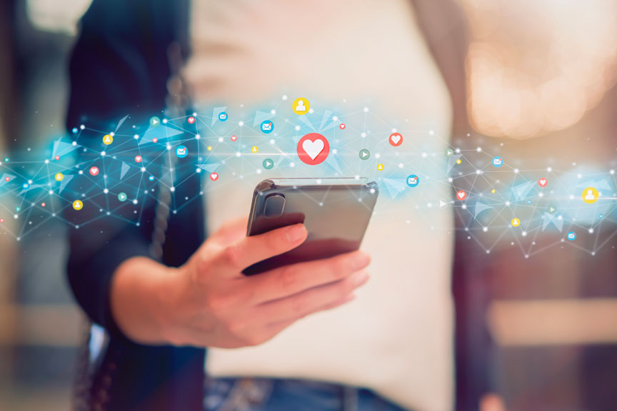 Hands Holding A Smartphone With Social Media Icons