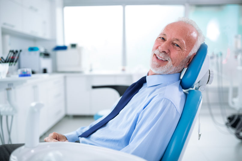 Smiling Man Sitting On A Dental Chair