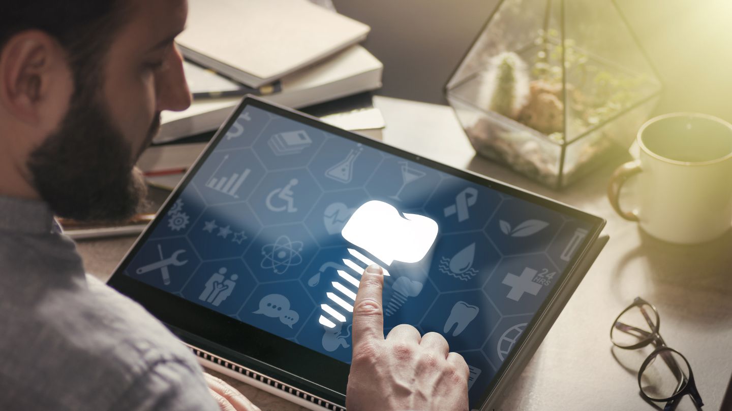 Person Using A Tablet Having Dental Graphics
