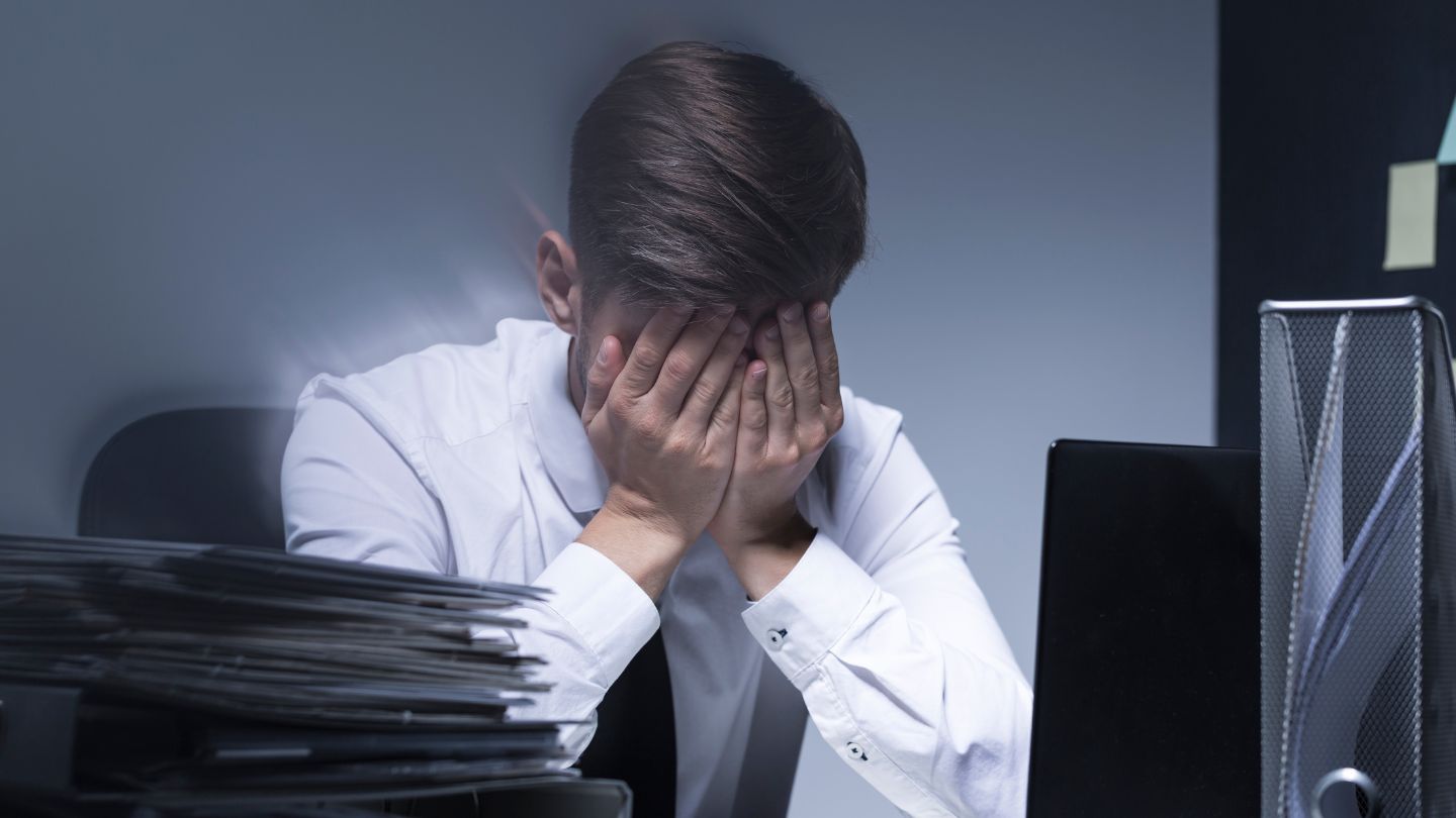 Stressed Person With Hands On Face