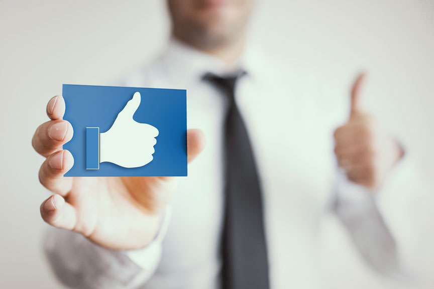 Person Holding A Thumbs Up Card