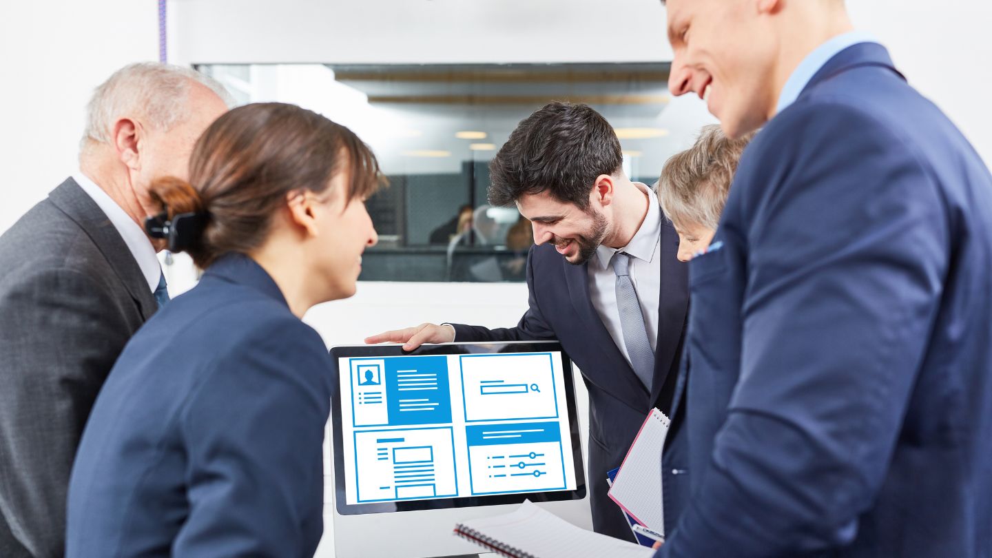 Business Team Analyzing Data On Screen