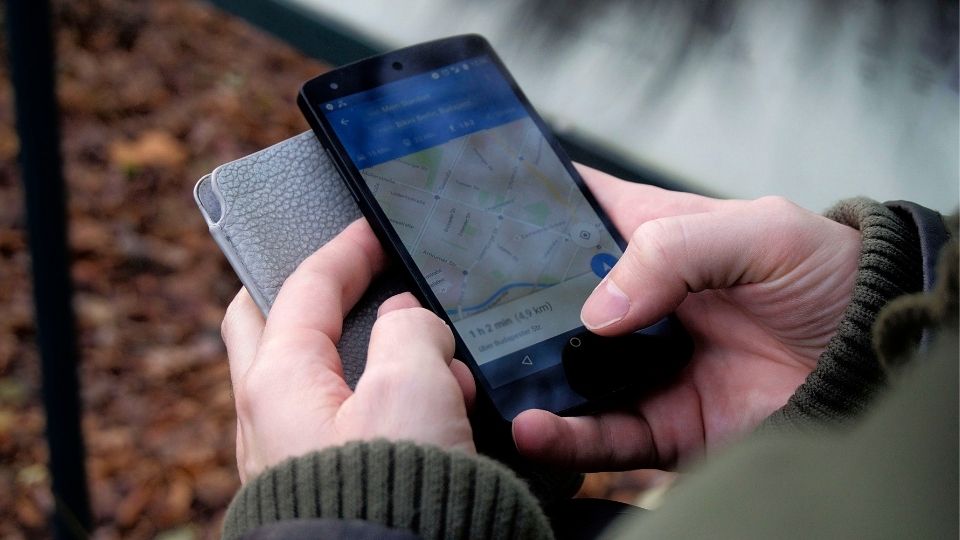 Hands Holding A Smartphone With Google Maps