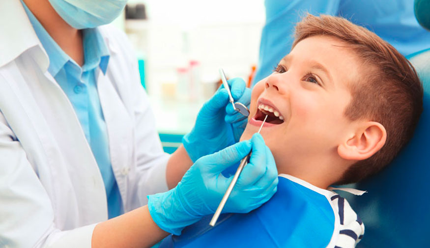 Dentist Examining A Child Patient