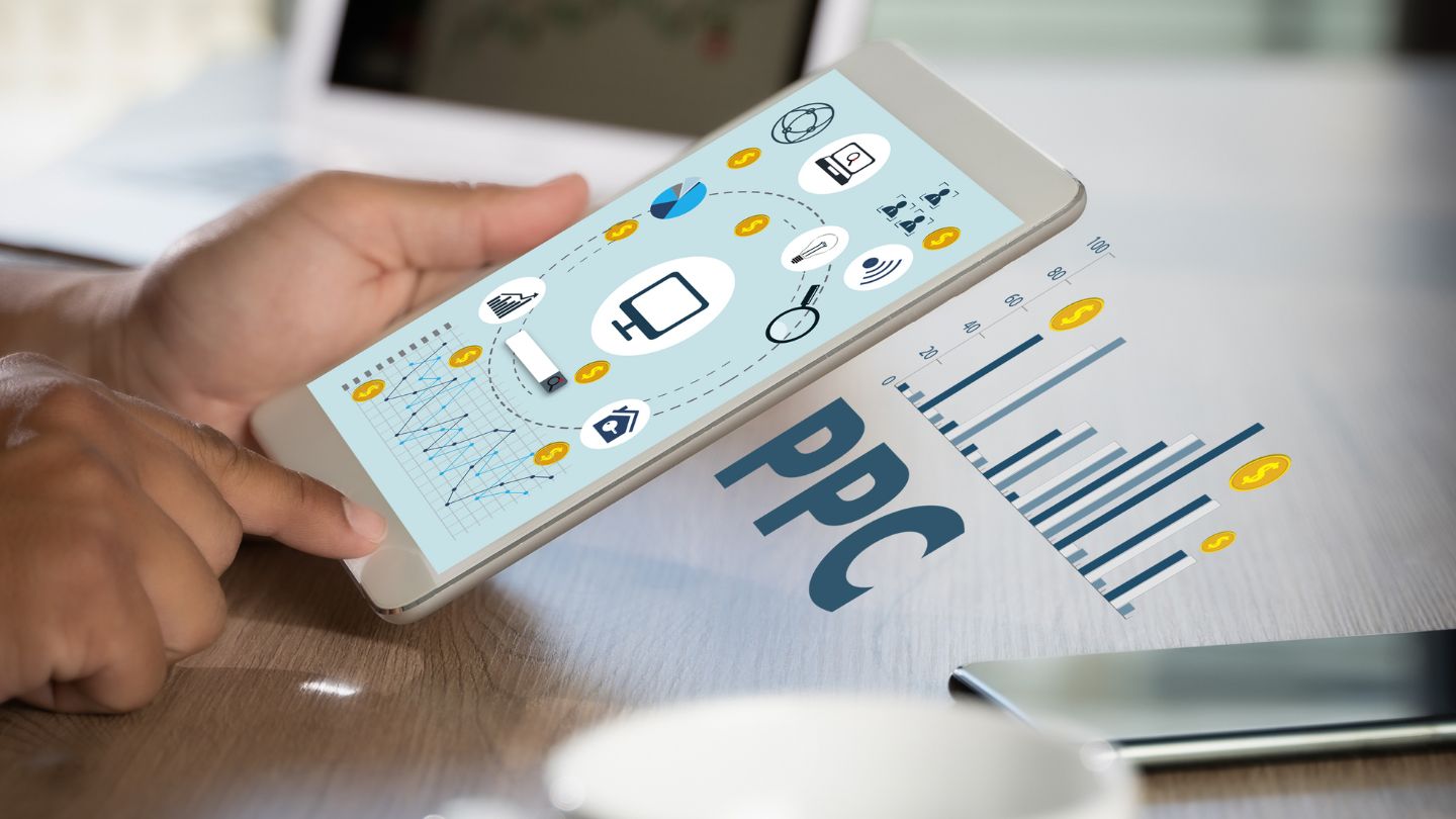 Person Holding A Tablet Displaying SEO And PPC Icons 1
