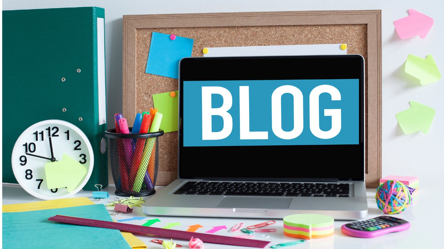 Laptop On A Desk With Blog Text On The Screen