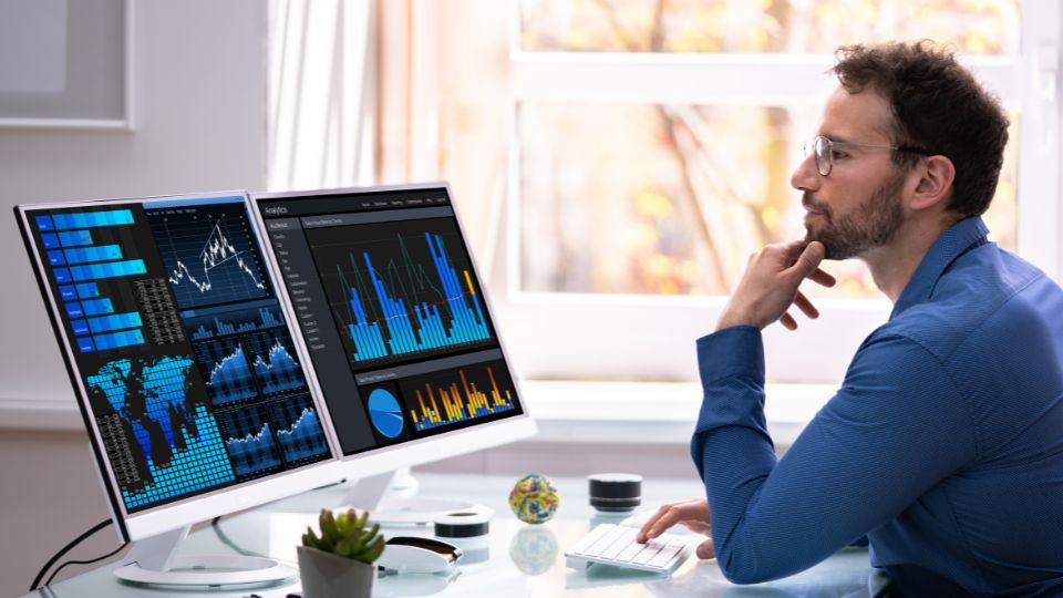 Man Analyzing Data On Laptop