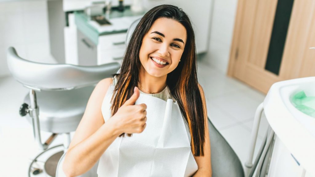 Woman In A Dental Chair Giving A Thumbs Up